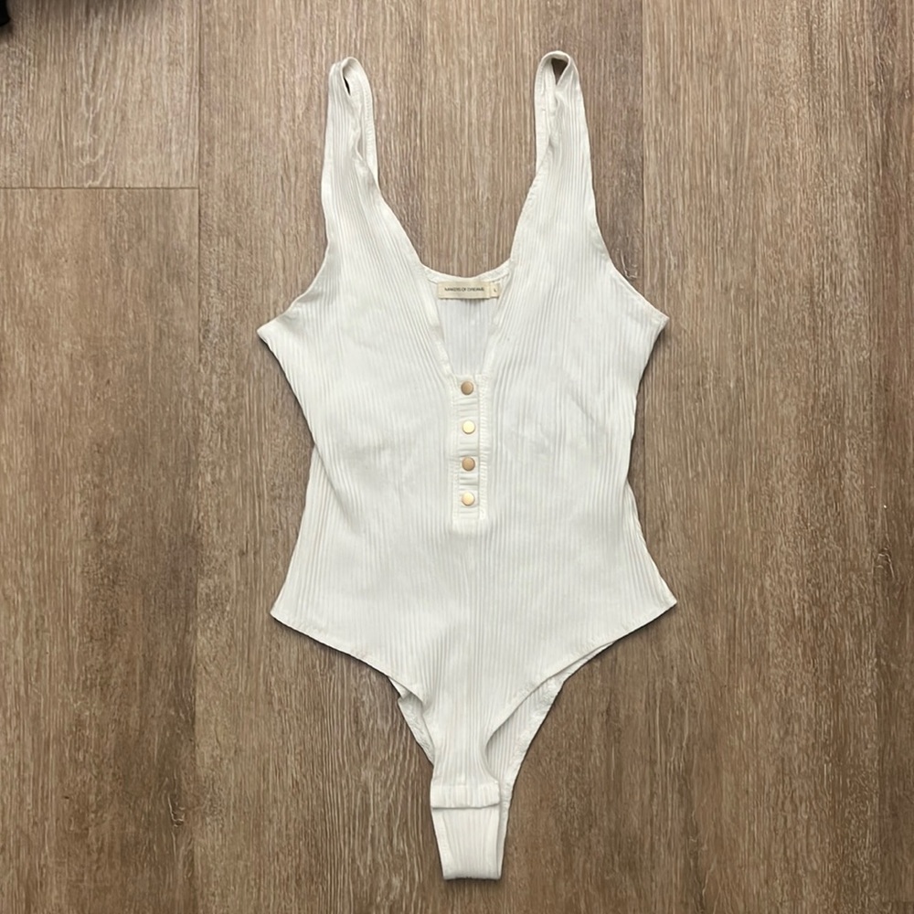 White bodysuit with gold buttons